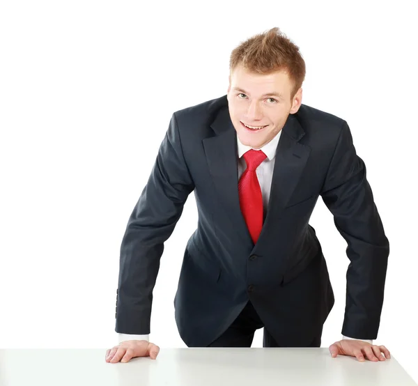 Young bussinesman standing near table — Stock Photo, Image