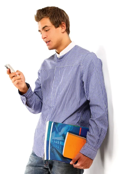 A young college guy with books and phone