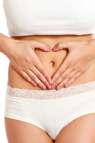 Hands on a female belly — Stock Photo, Image