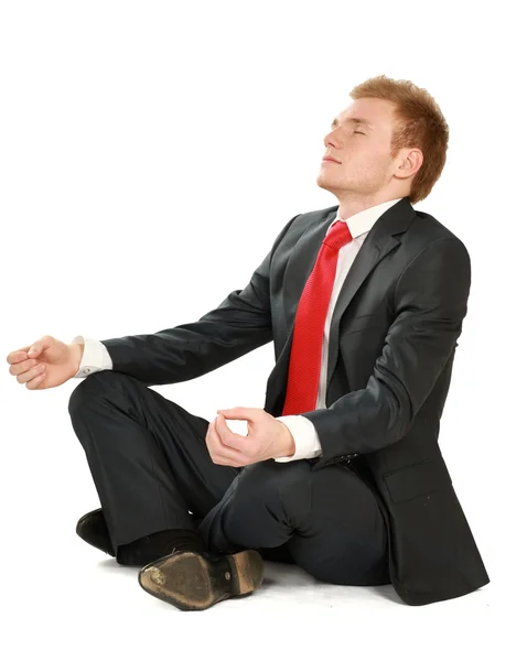 Een jonge man zittend op de vloer — Stockfoto