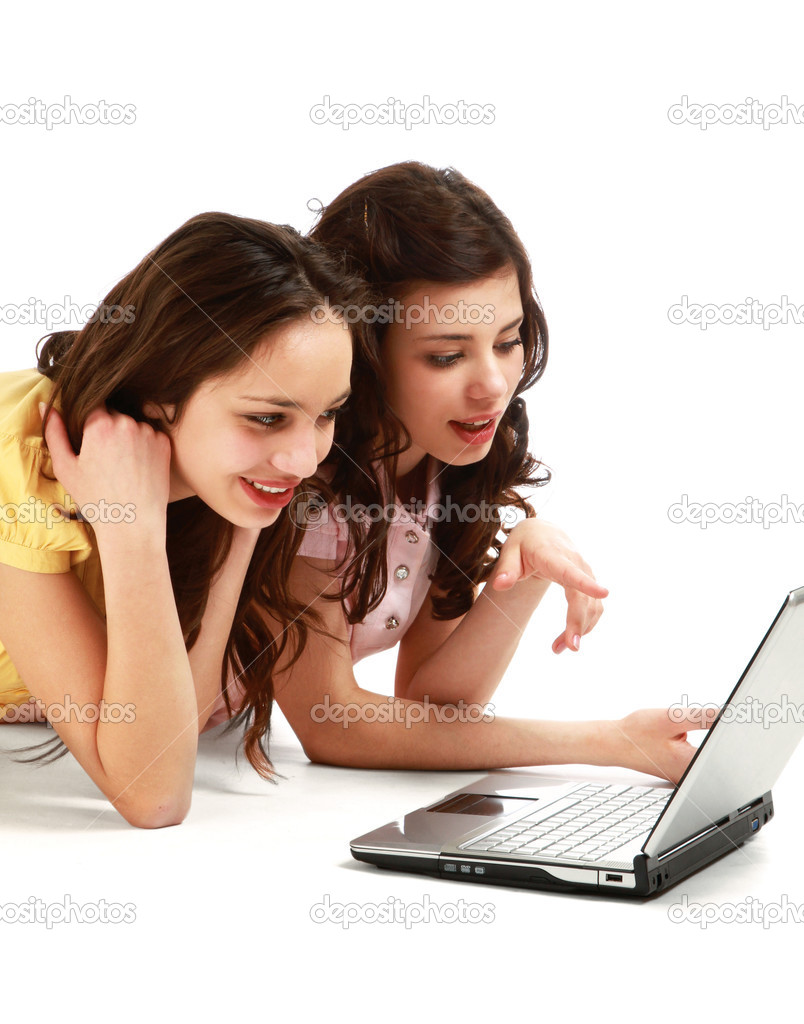Two girls twins with laptop isolated on the white