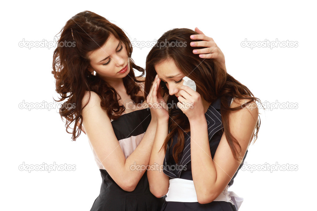 A young girl crying and a friend calming her