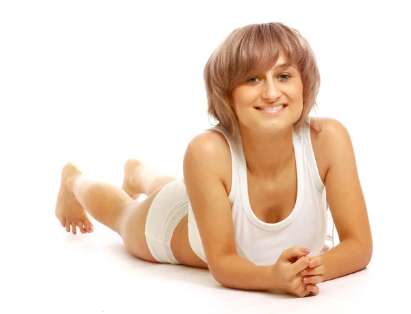 A beautiful young woman lying on the floor — Stock Photo, Image