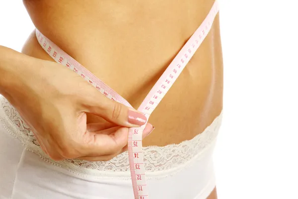 A slim girl measuring her waist — Stock Photo, Image