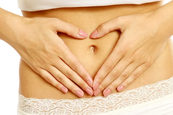 Hands on a female belly — Stock Photo, Image