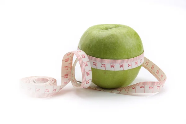 A green apple and a measurement tape — Stock Photo, Image