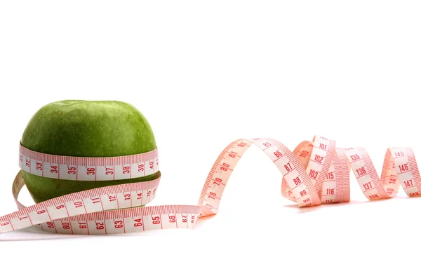 A green apple and a measurement tape — Stock Photo, Image