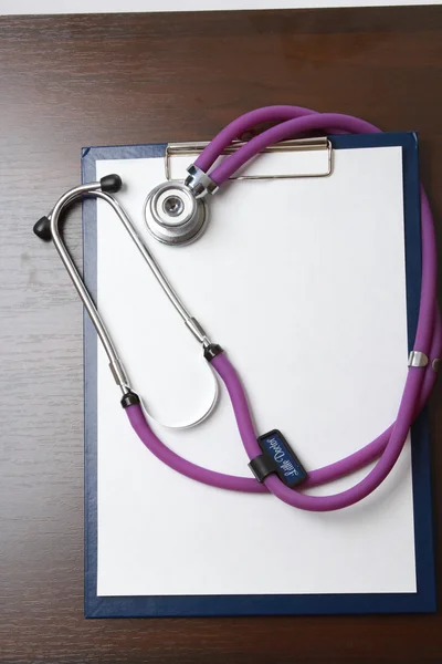 Medical stethoscope on a clipboard — Stock Photo, Image