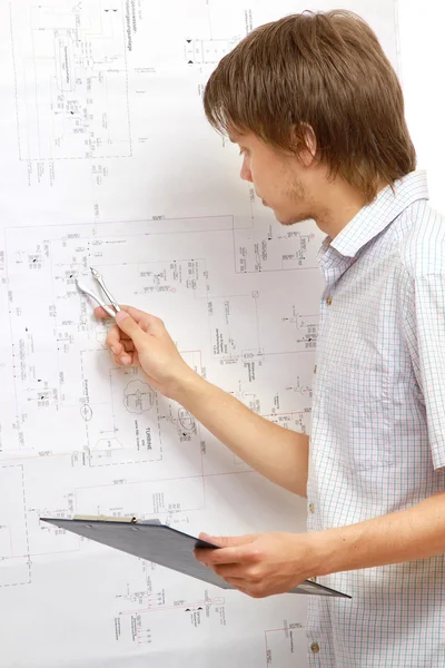 A young man near a diagram — Stock Photo, Image