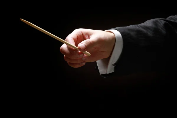 A concert conductor's hands with a baton — Stock Photo, Image