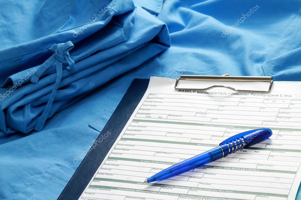 Clipboard and a pen on a medical uniform