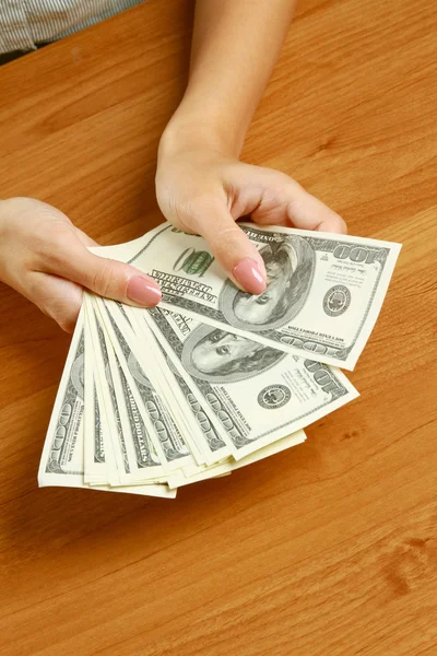 Female hands holding dollars — Stock Photo, Image