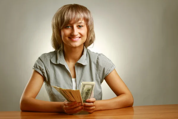 A young woman holding dollars — Stock Photo, Image