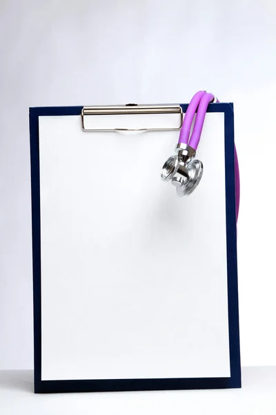 A medical stethoscope on a clipboard — Stock Photo, Image