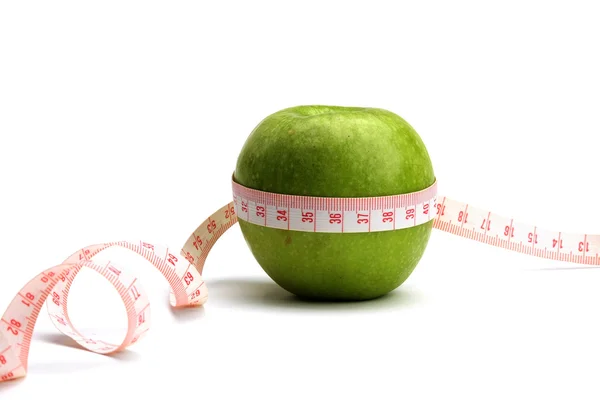 An apple is measured with a measure tape — Stock Photo, Image