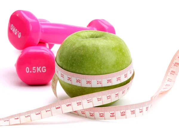 An apple, a measuring tape and dumbbell — Stock Photo, Image