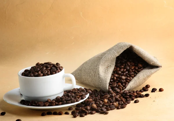 A sack of coffee beans and a cup — Stock Photo, Image