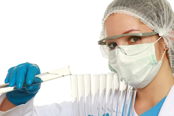 A young woman examining test tubes — Stock Photo, Image