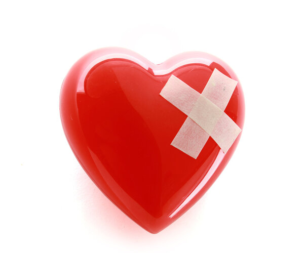 A red heart with adhesive plaster