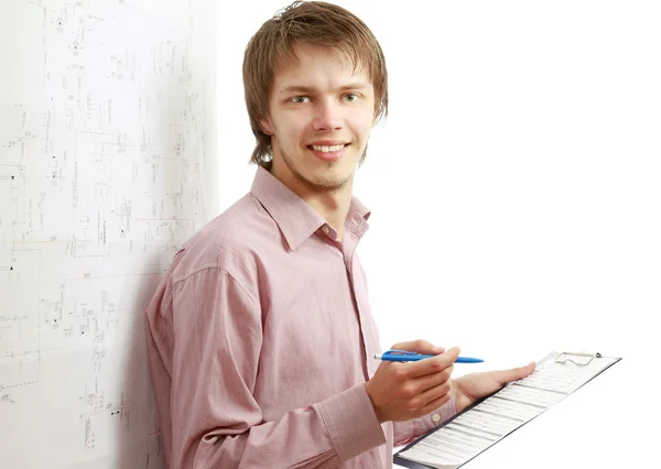 A smiling businessman is filling papers — Stock Photo, Image