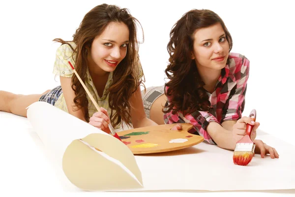 Young girls are painting and lying on the floor — Stock Photo, Image