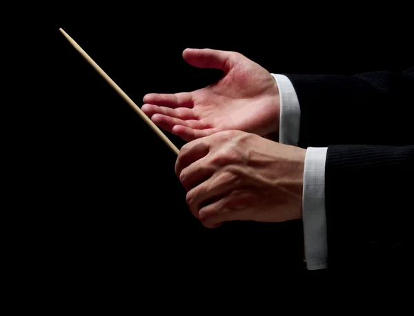 Hands of a conductor on black background — Stock Photo, Image
