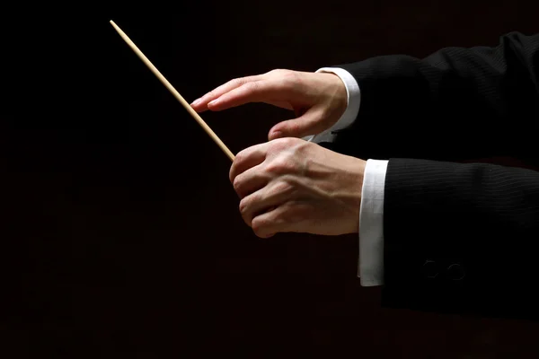 Hands of conductor with baton — Stock Photo, Image