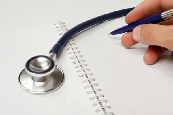 Stethoscope on medical billing statement on table, all text is anonymous. — Stock Photo, Image