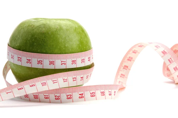 Zelené jablko a měřicí pásky — Stock fotografie