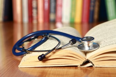 A stethoscope is lying with a book
