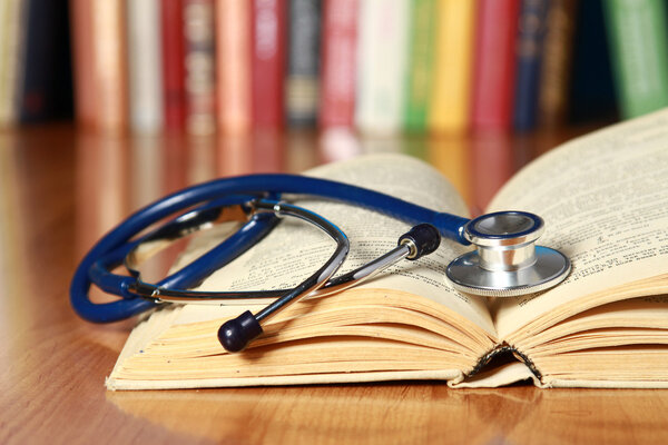 A stethoscope is lying with a book