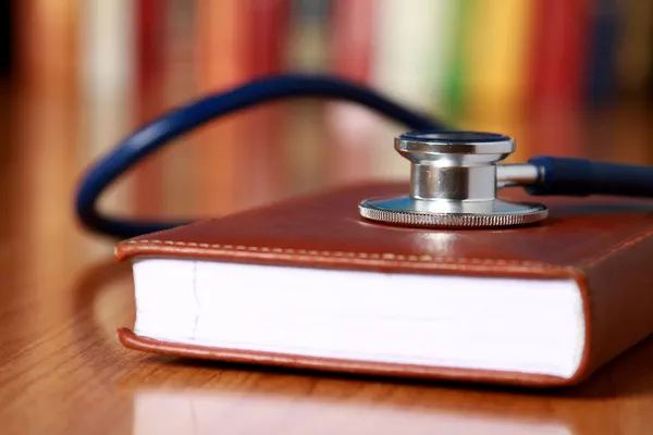 anotebook üzerinde yatan bir stetoskop
