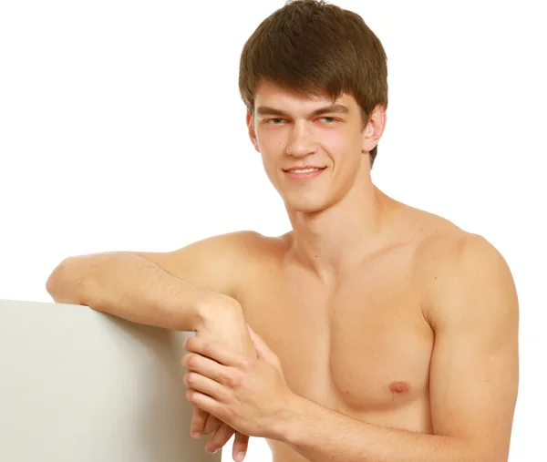 A shirtless athletic man near a blank — Stock Photo, Image