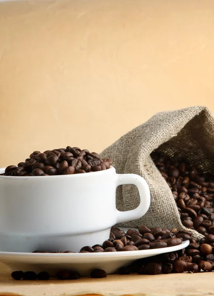 A sack of coffee beans and a cup — Stock Photo, Image