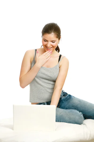 Young girl using a laptop on a sofa — Stock Photo, Image