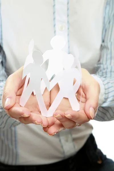 Female hands holding paper people — Stock Photo, Image