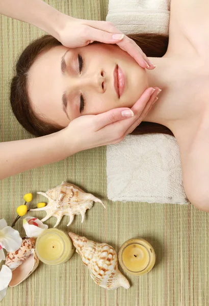 Mujer joven recibiendo masaje facial en el salón de spa —  Fotos de Stock