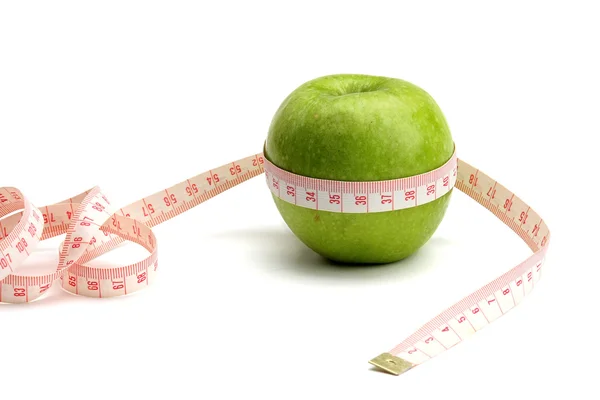 A green apple and a measuring tape — Stock Photo, Image