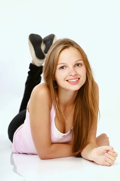 Young girl in jeans laying on floor — Stock Photo, Image