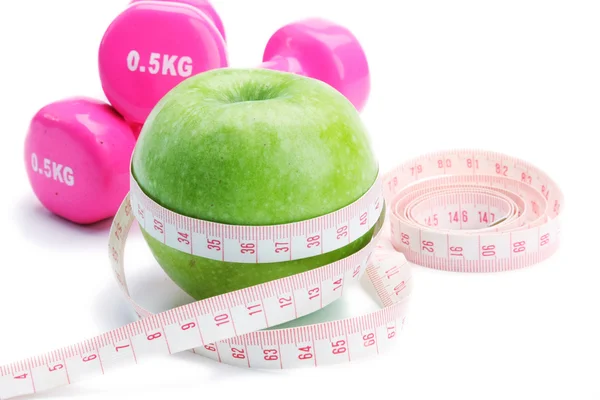 An apple, a measuring tape and dumbbell — Stock Photo, Image