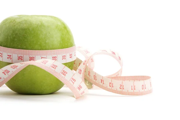 A green apple and a measurement tape — Stock Photo, Image