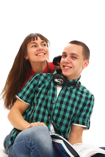 Uma menina e um cara com fones de ouvido — Fotografia de Stock