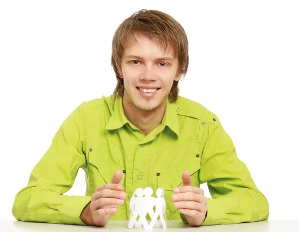 A young guy taking care of paper people — Stock Photo, Image