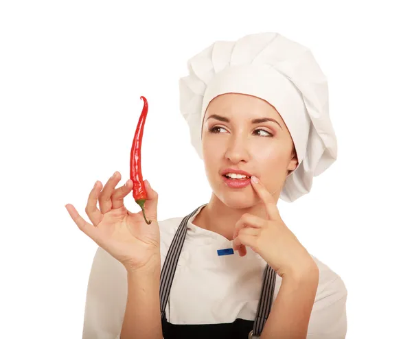 Young pretty woman cook with peppers Royalty Free Stock Images