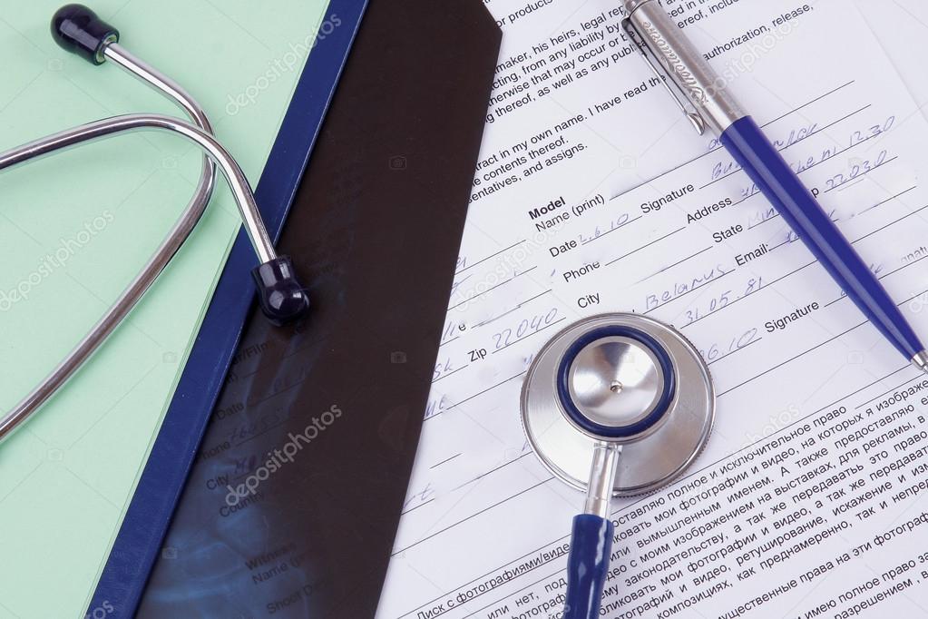 A stethoscope over medical papers