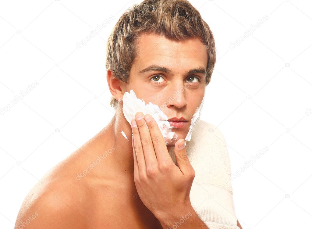 Closeup of a young man shaving