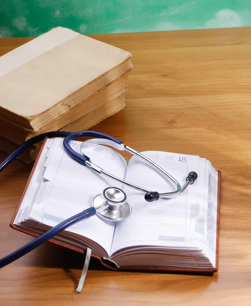 Stethoscope with reference books — Stock Photo, Image