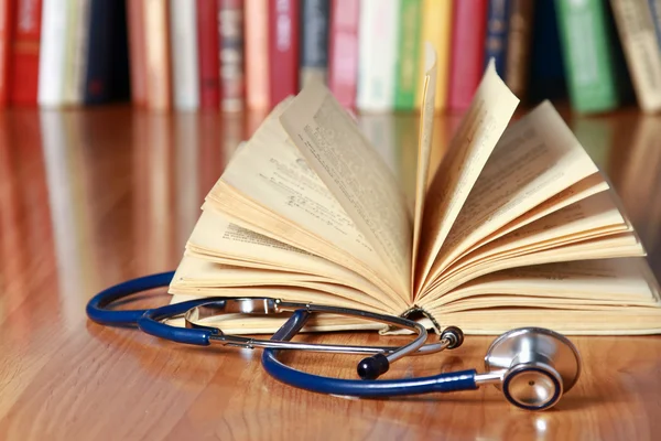 A stethoscope is lying with a book — Stock Photo, Image