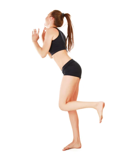 Mujer joven en negro practicando yoga — Foto de Stock