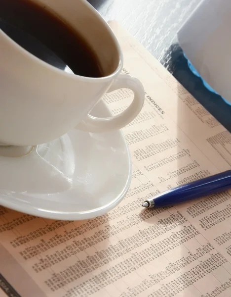 Cup of coffee near press. — Stock Photo, Image